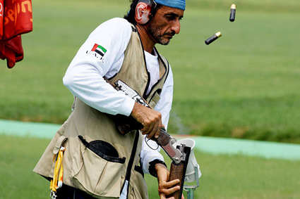  Emirati shooter Sheikh Ahmed bin Hasher al-Maktoum, a member of Dubai's ruling family, empties cartridges from his rifle during the men's trap shooting qualifications for the 2008 Beijing Olympics at the Shooting Range Hall in the Chinese capital on August 9, 2008. AFP PHOTO/ISSOUF SANOGO